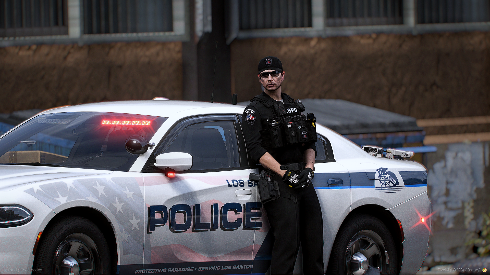 Los Santos Police Department Charger livery with officer standing beside the cruiser in FiveM